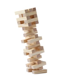 Jenga tower made of wooden blocks falling on white background