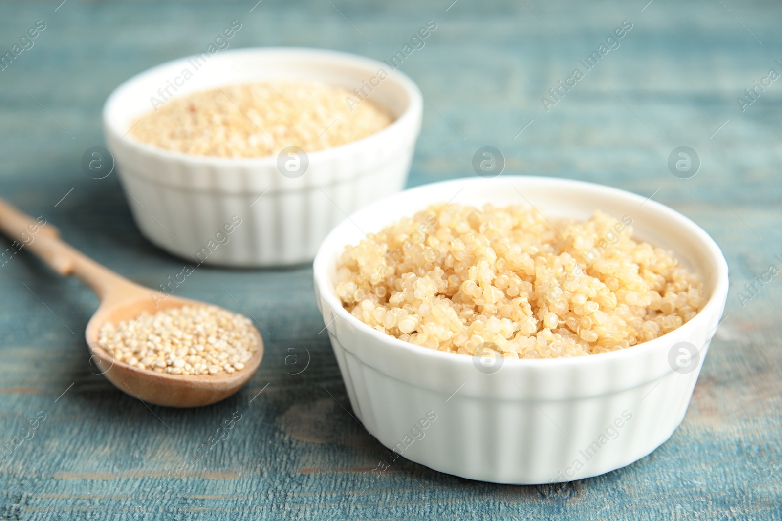 Photo of Composition with cooked quinoa in small bowl on table