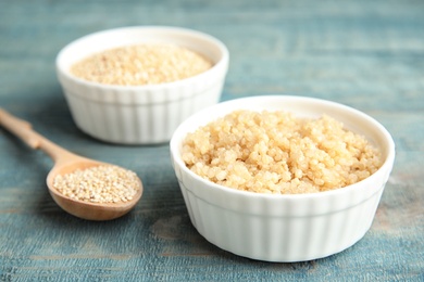 Composition with cooked quinoa in small bowl on table