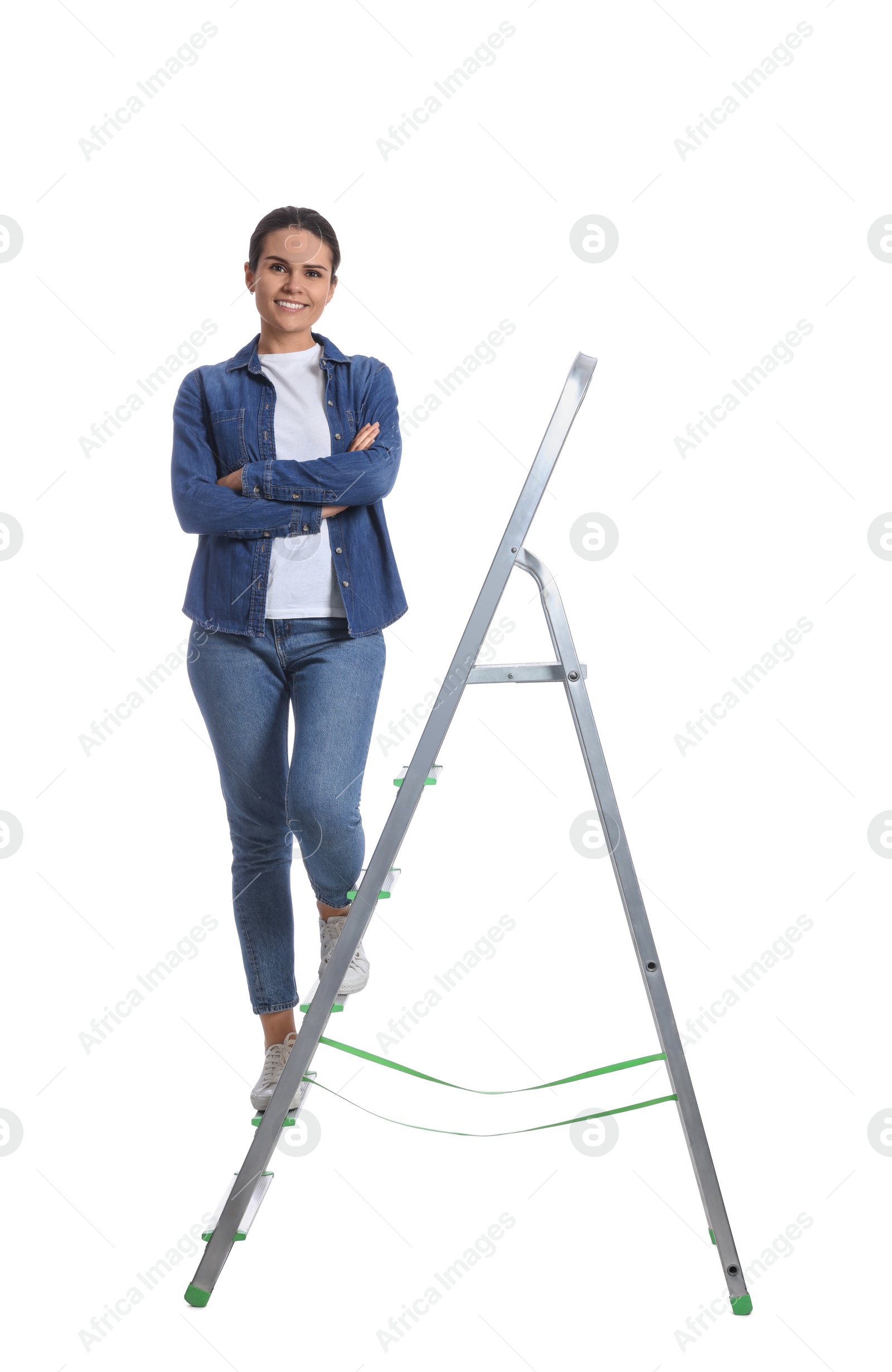 Photo of Young woman on metal ladder against white background