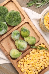 Photo of Tray with different frozen vegetables on wooden table, top view