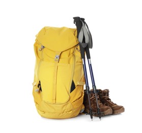Photo of Trekking poles, backpack and boots on white background
