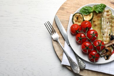 Delicious grilled vegetables served on white wooden table, top view. Space for text