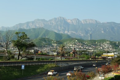 Picturesque view of city and highway in mountains