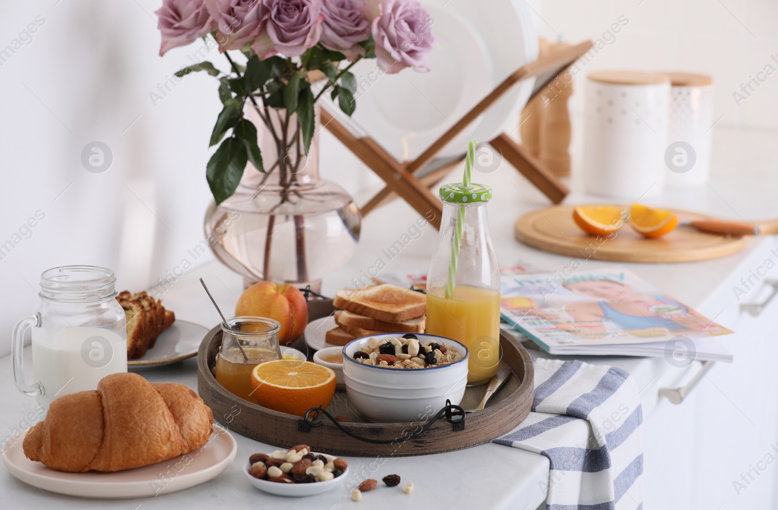 Photo of Tray with tasty breakfast on white table in morning.  Space for text