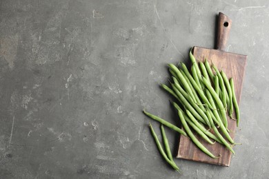 Fresh green beans on grey table, flat lay. Space for text