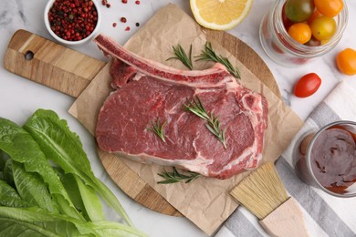 Flat lay composition with raw meat, rosemary and marinade on white table