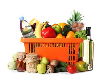 Shopping basket and grocery products on white background