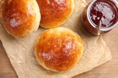 Tasty scones prepared on soda water and jam on wooden table, flat lay