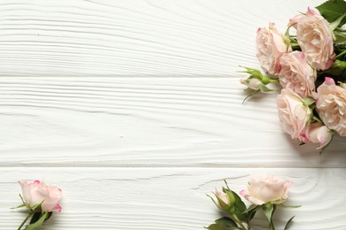 Happy Mother's Day. Beautiful roses on white wooden table, flat lay. Space for text