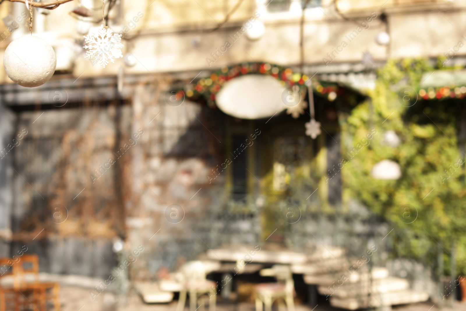 Photo of Blurred view of building with green vine on sunny day