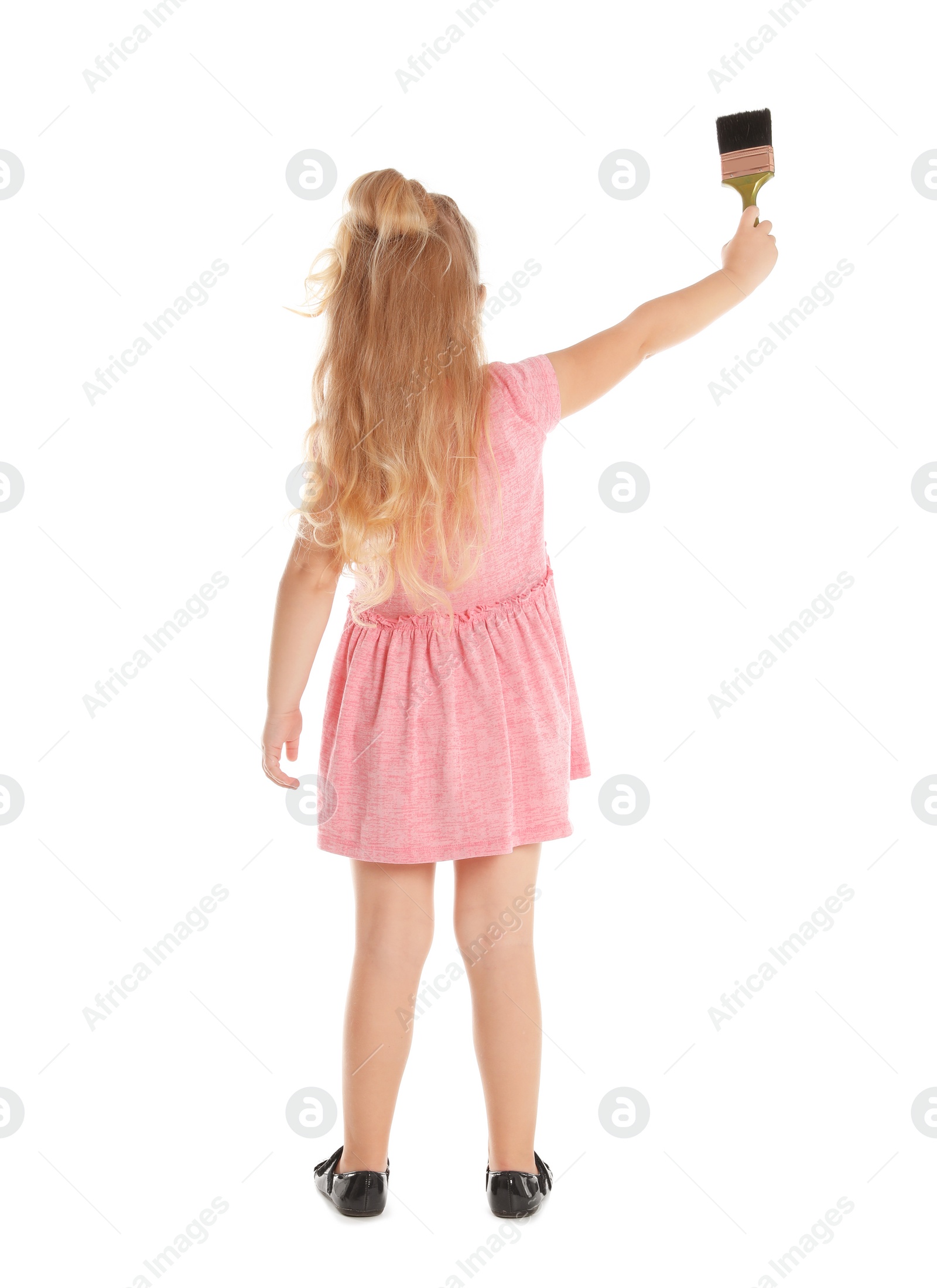 Photo of Little child painting something with brush on white background