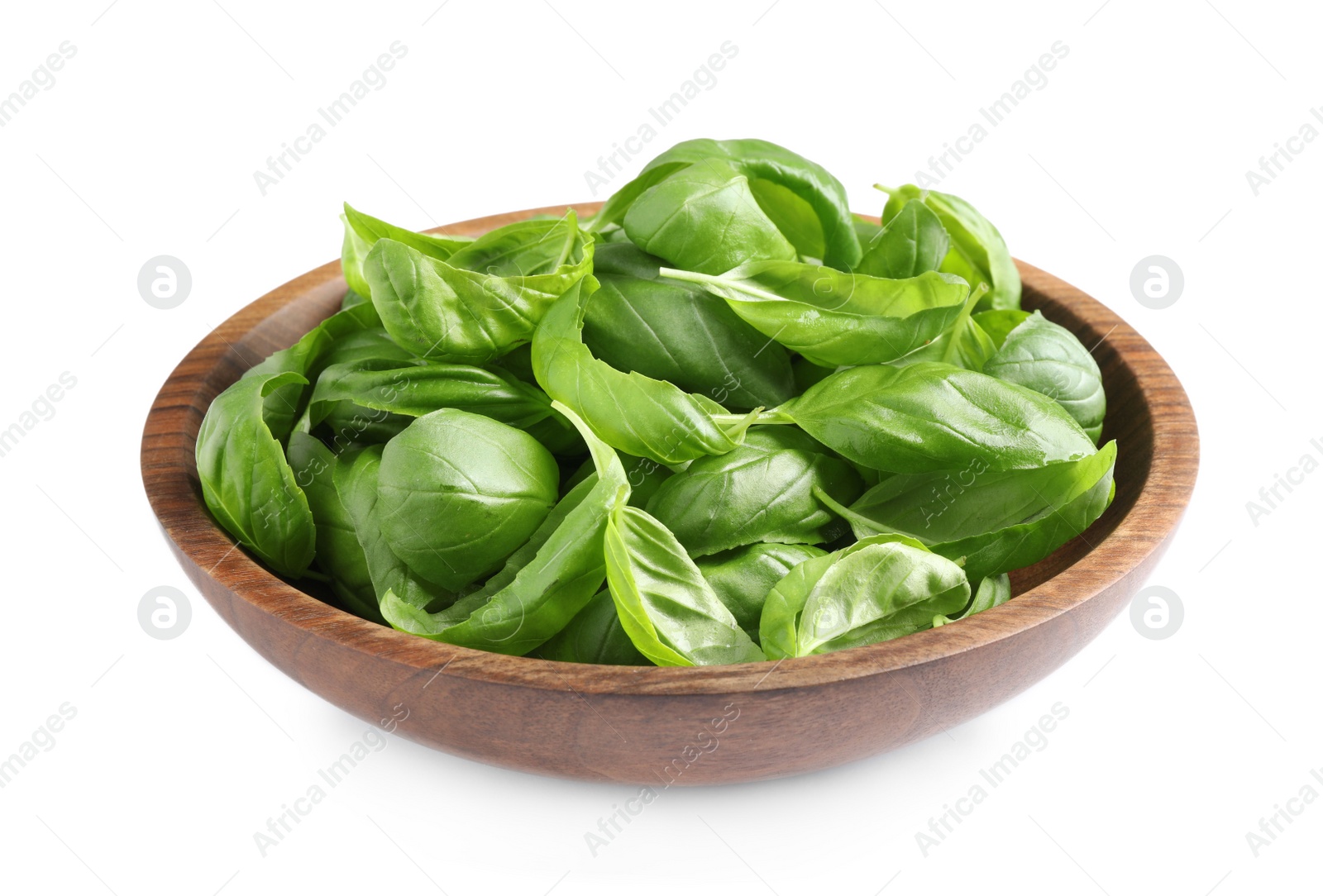 Photo of Fresh basil leaves in wooden bowl isolated on white