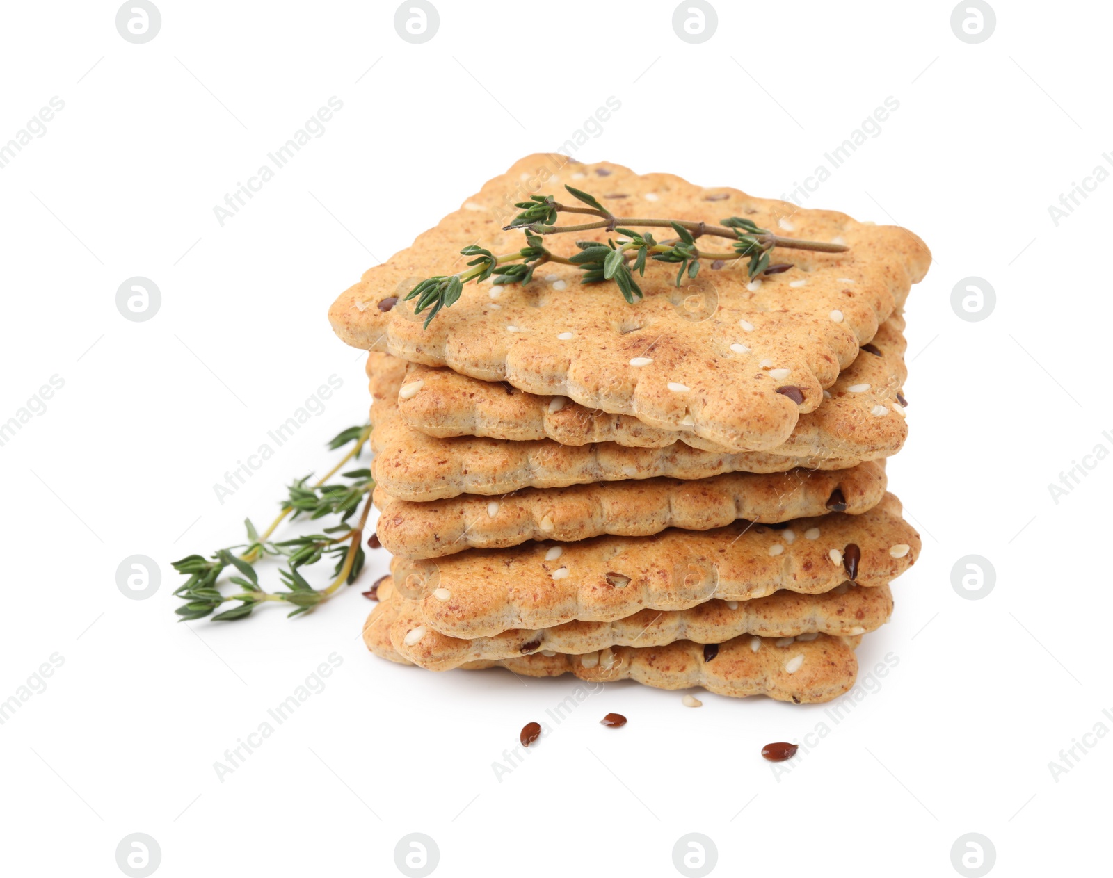 Photo of Stack of cereal crackers with flax, sesame seeds and thyme isolated on white