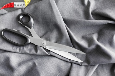 Scissors and measuring tape for tailoring on fabric