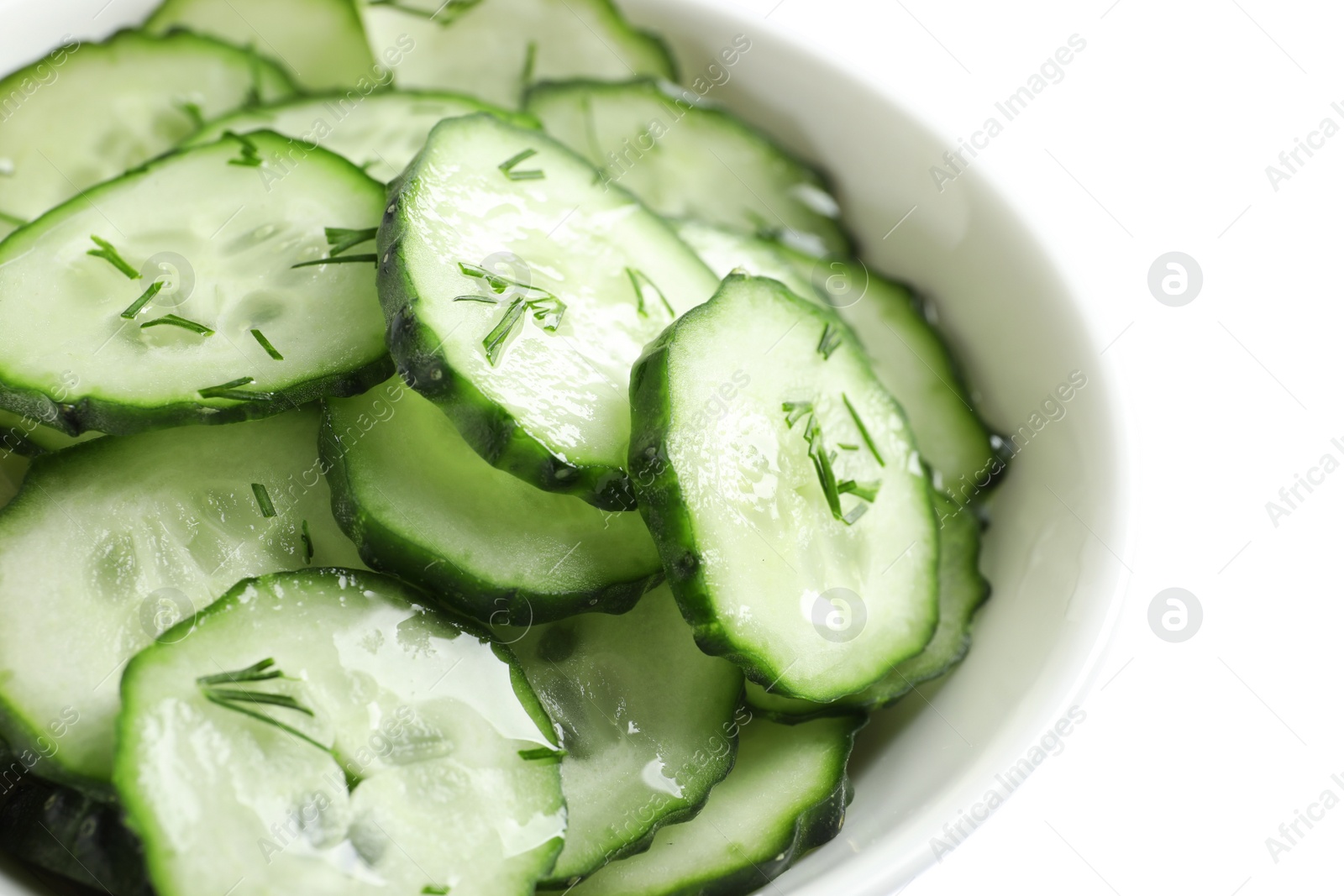 Photo of Delicious cucumber salad with dill in bowl on white background, closeup