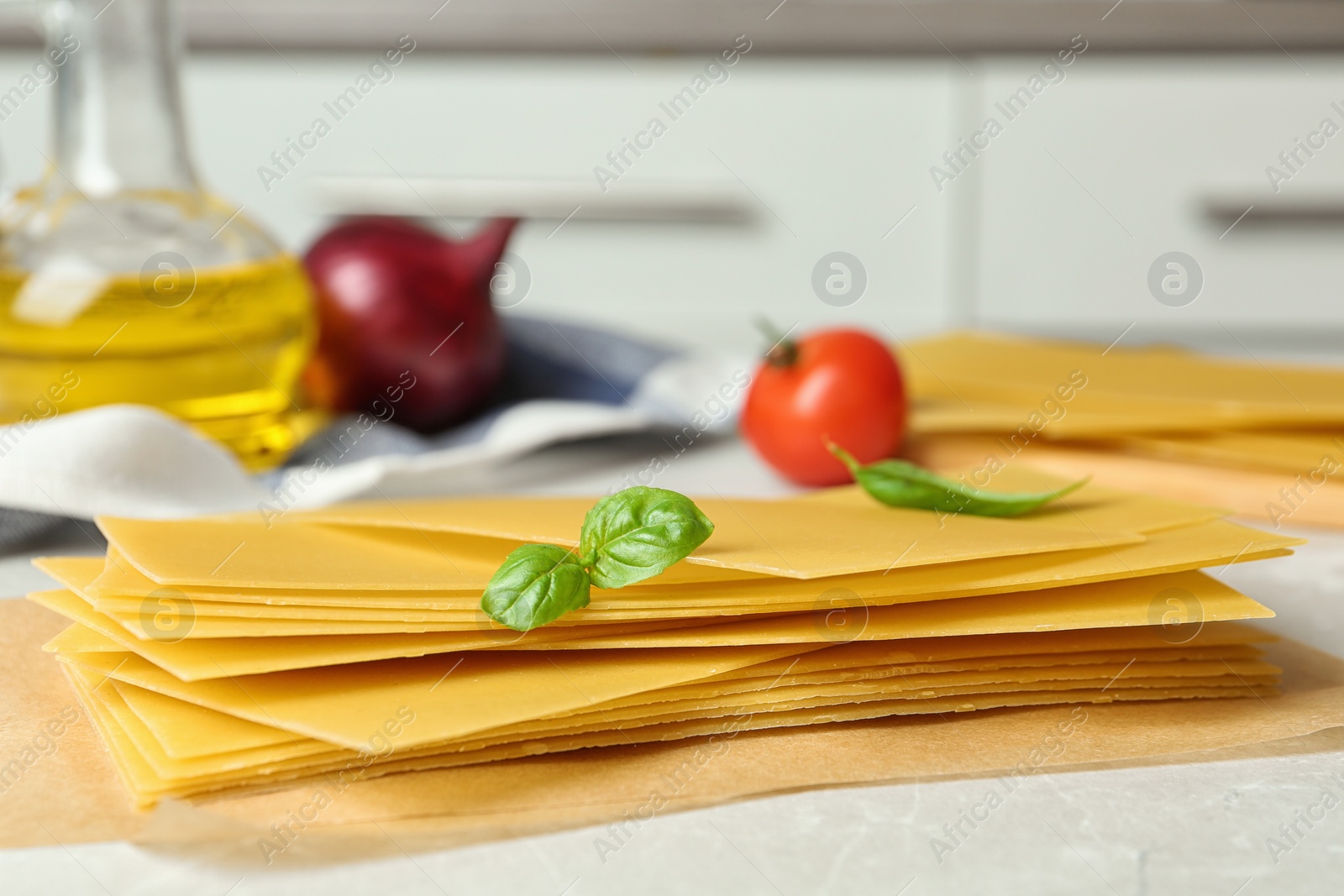 Photo of Composition with uncooked lasagna sheets on marble table, closeup