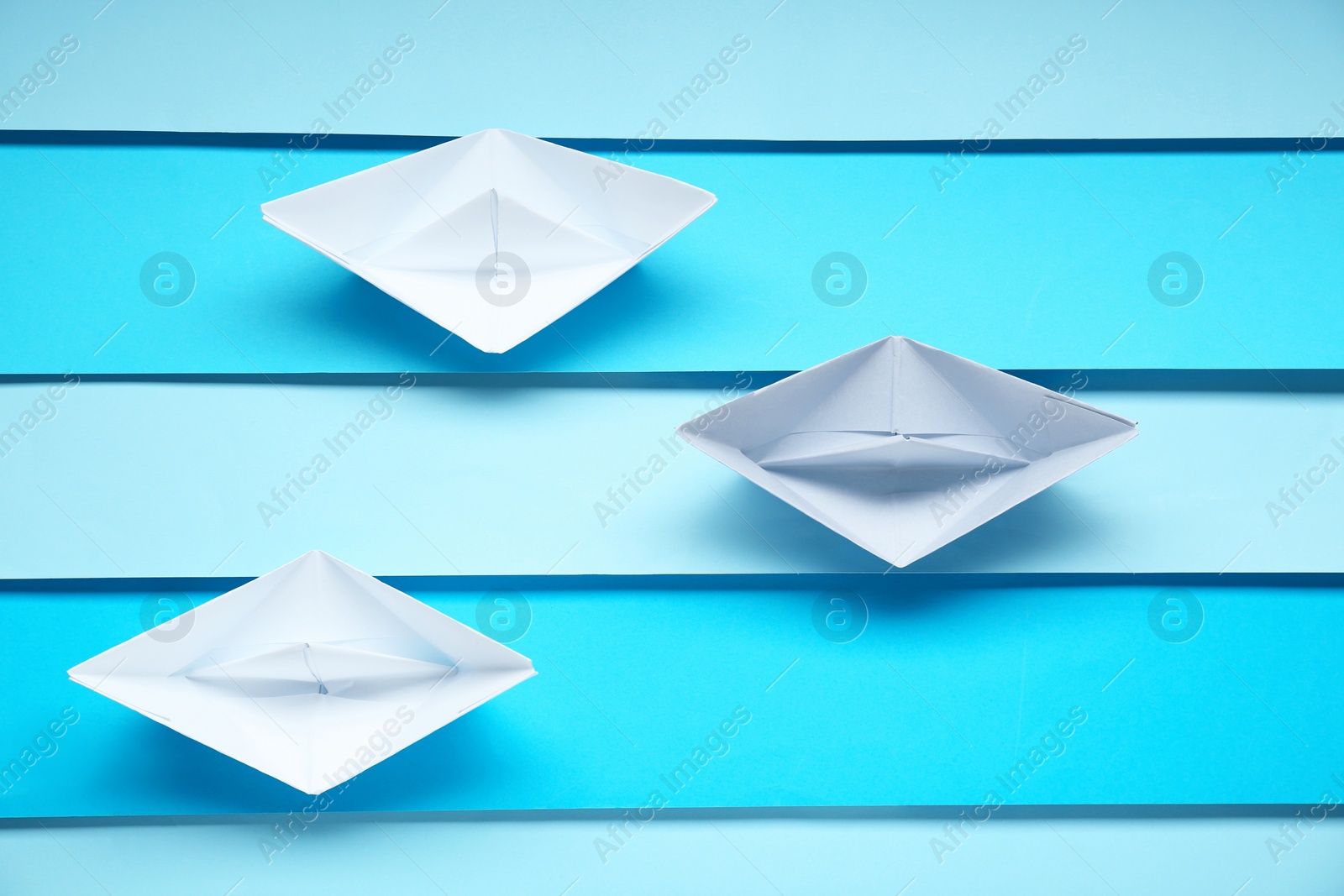 Photo of Competition concept. Paper boats on colorful background, flat lay