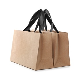 Photo of Paper shopping bags with handles on white background. Mockup for design