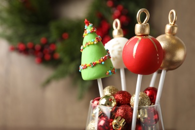 Photo of Delicious Christmas themed cake pops on blurred background. Space for text