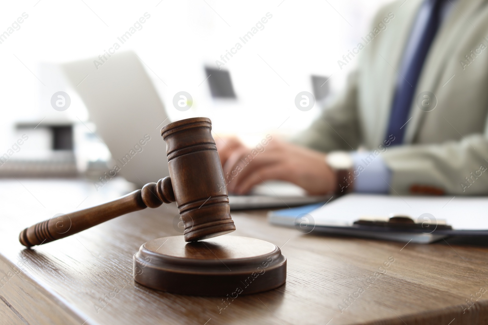 Photo of Gavel on table and lawyer in office