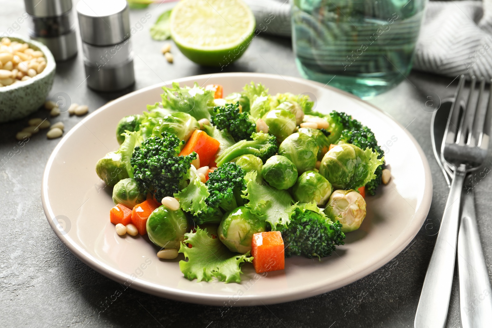 Photo of Plate of salad with Brussels sprouts served on table