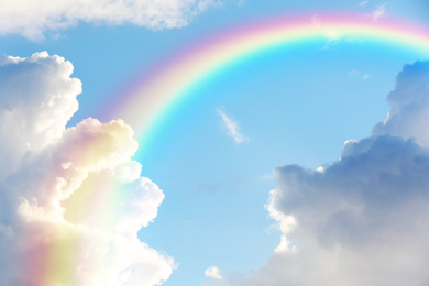 Image of Picturesque view of beautiful rainbow and blue sky on sunny day 