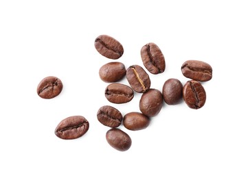 Photo of Many roasted coffee beans isolated on white, top view