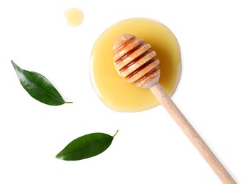 Photo of Wooden dipper with fresh honey and green leaves on white background, top view