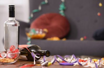 Photo of Messy table with bottles after party indoors, closeup