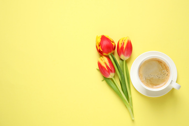 Photo of Spring tulips and coffee on yellow background, flat lay with space for text. Good morning