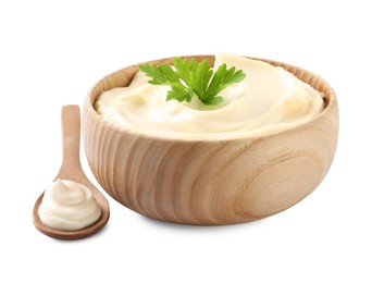 Photo of Spoon and bowl of delicious mayonnaise with parsley on white background