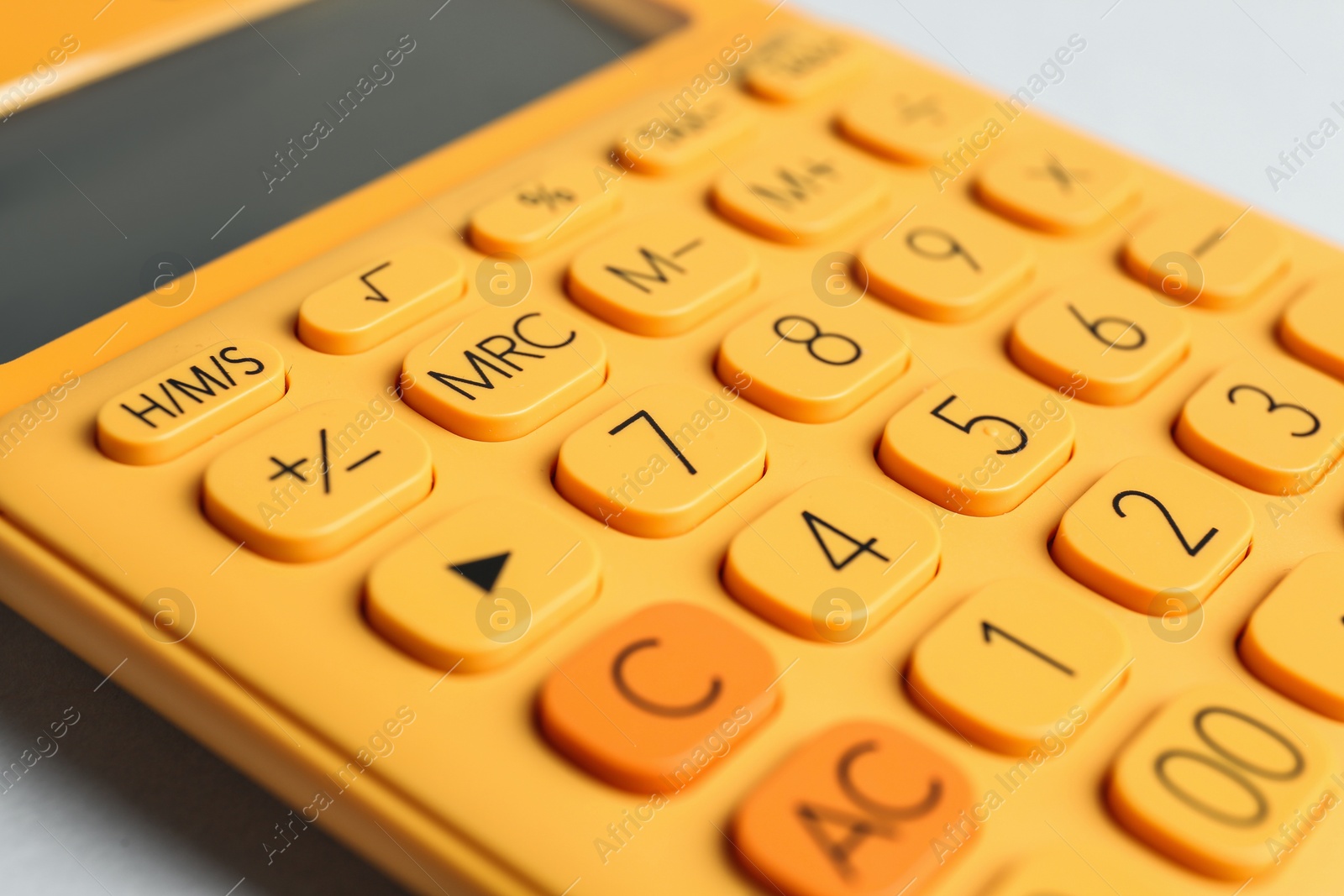 Photo of Closeup view of orange calculator on light background