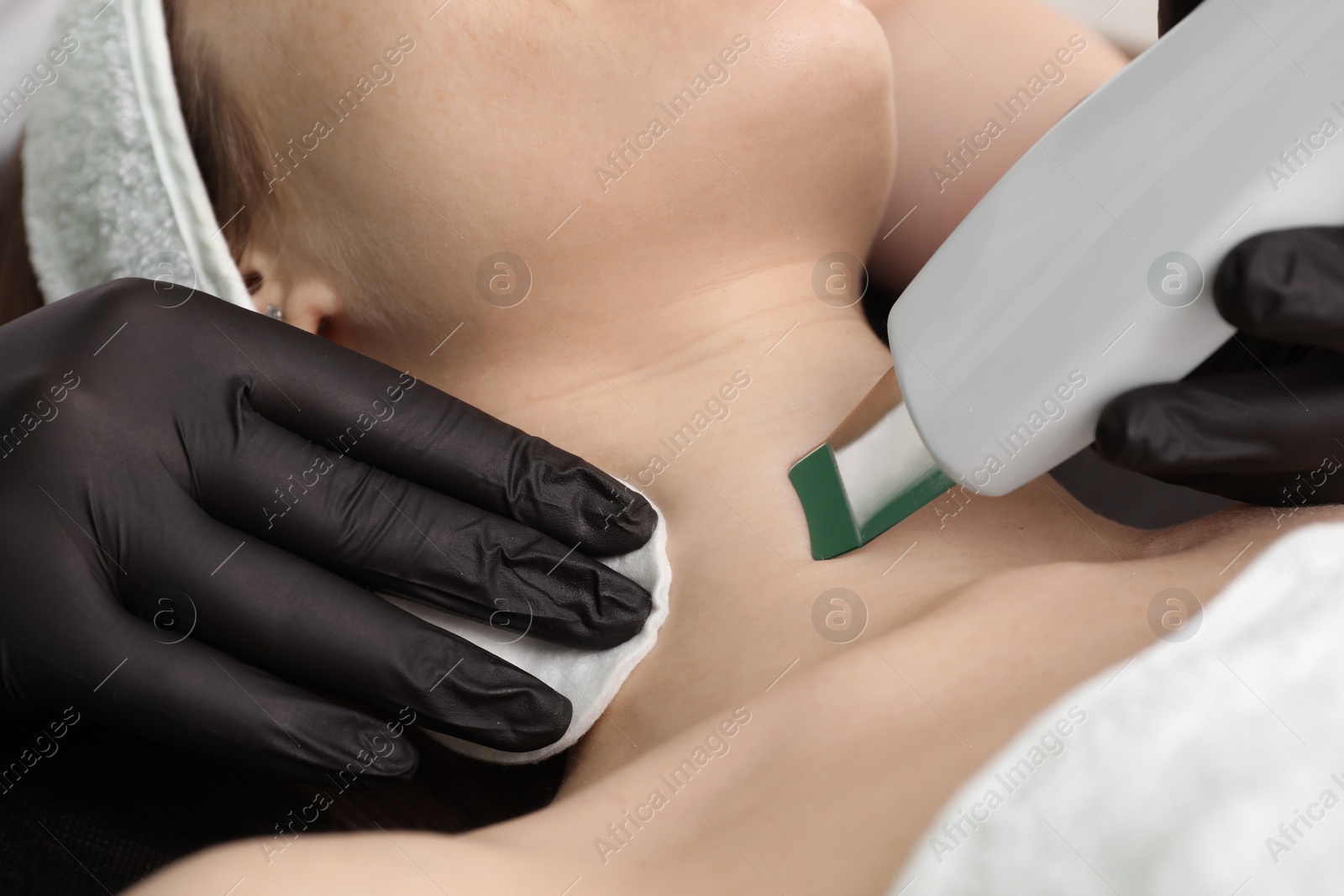 Photo of Cosmetologist using ultrasonic scrubber, closeup. Client having cleansing procedure