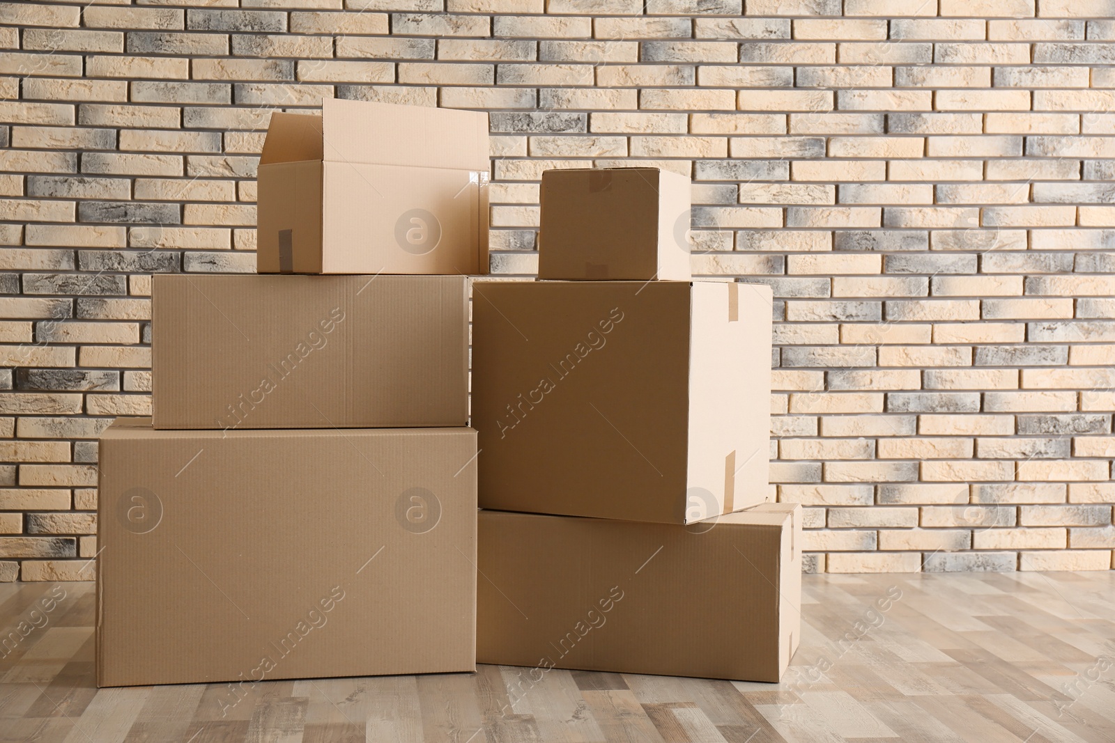 Photo of Pile of moving boxes in empty room