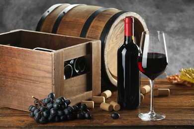 Photo of Winemaking. Composition with tasty wine and barrel on wooden table