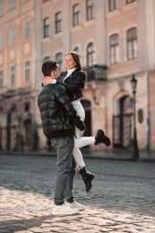 Photo of Lovely young couple having fun together on city street. Romantic date