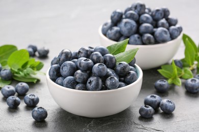 Tasty fresh blueberries on grey table, closeup