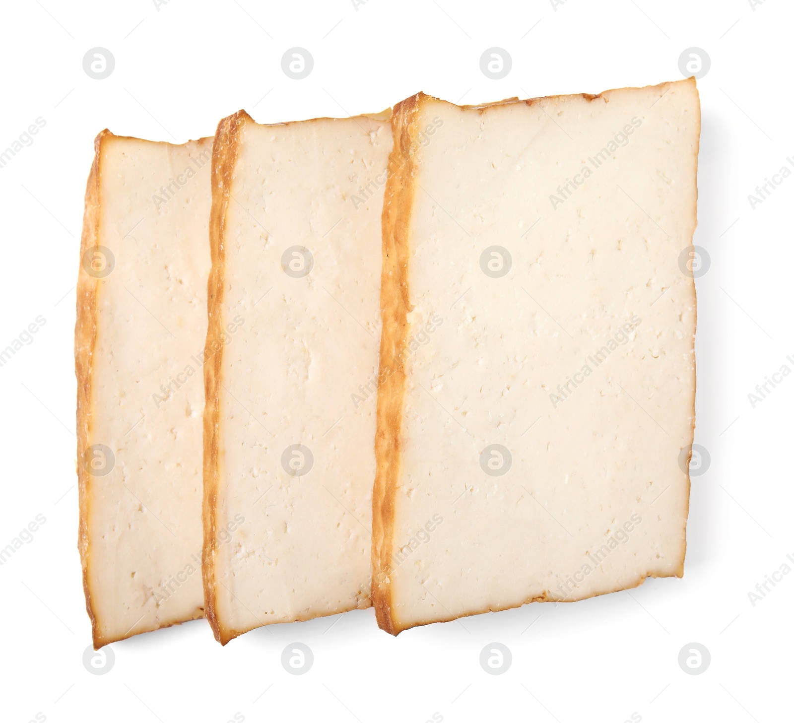 Photo of Slices of delicious smoked tofu isolated on white, top view