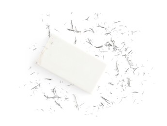 Photo of Eraser and grey crumbs on white background, top view