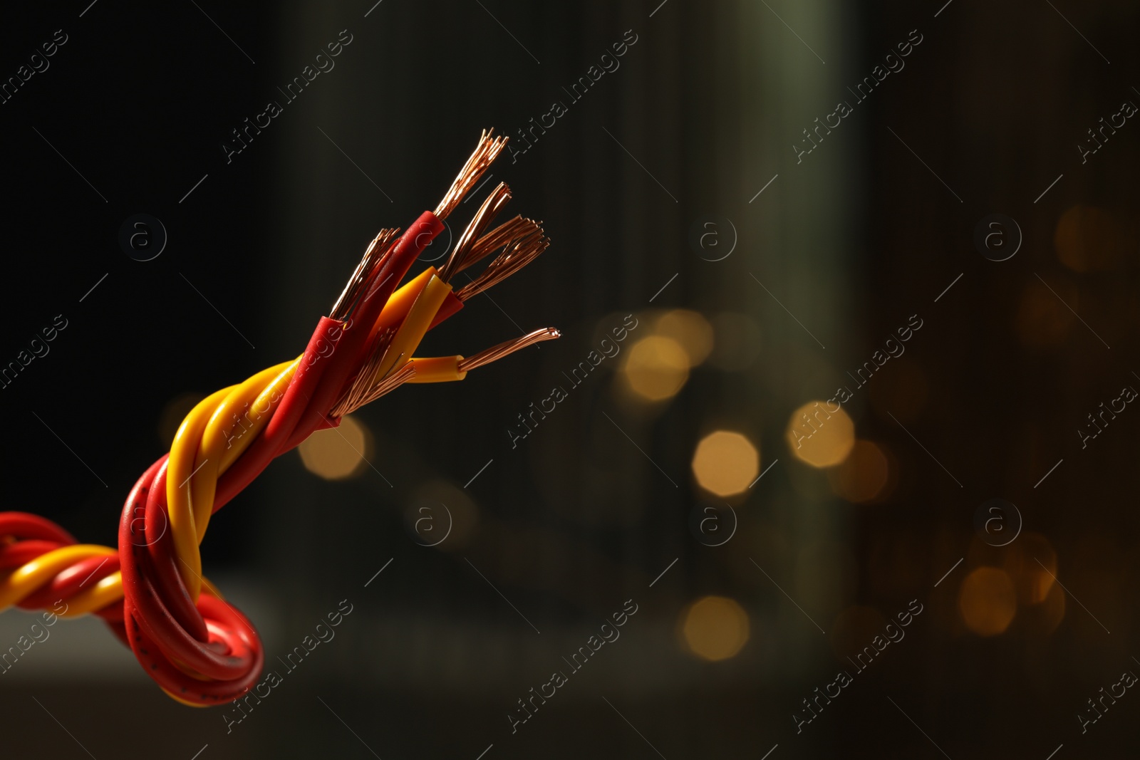 Photo of Stranded copper wires with insulation against blurred background, closeup. Space for text