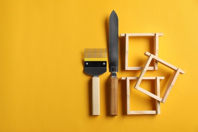 Photo of Beekeeping tools on yellow background, flat lay. Space for text