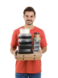 Young courier with pizza boxes, containers and drinks on white background. Food delivery service