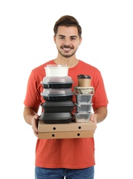 Photo of Young courier with pizza boxes, containers and drinks on white background. Food delivery service