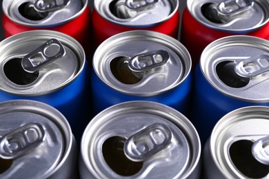 Photo of Energy drinks in cans as background, closeup. Functional beverage