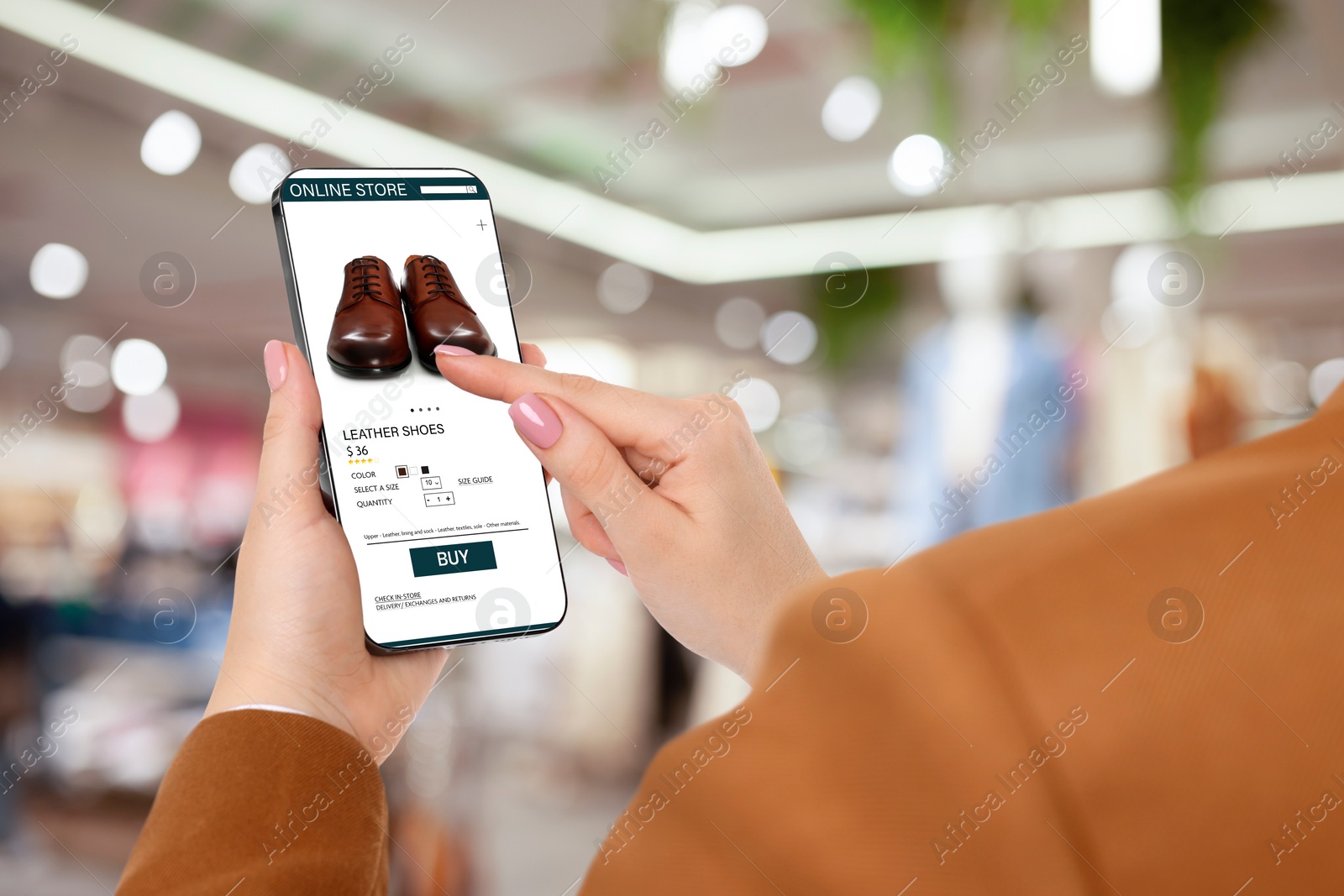 Image of Woman visiting shop to take ordered shoes indoors, closeup. Online store website on device screen