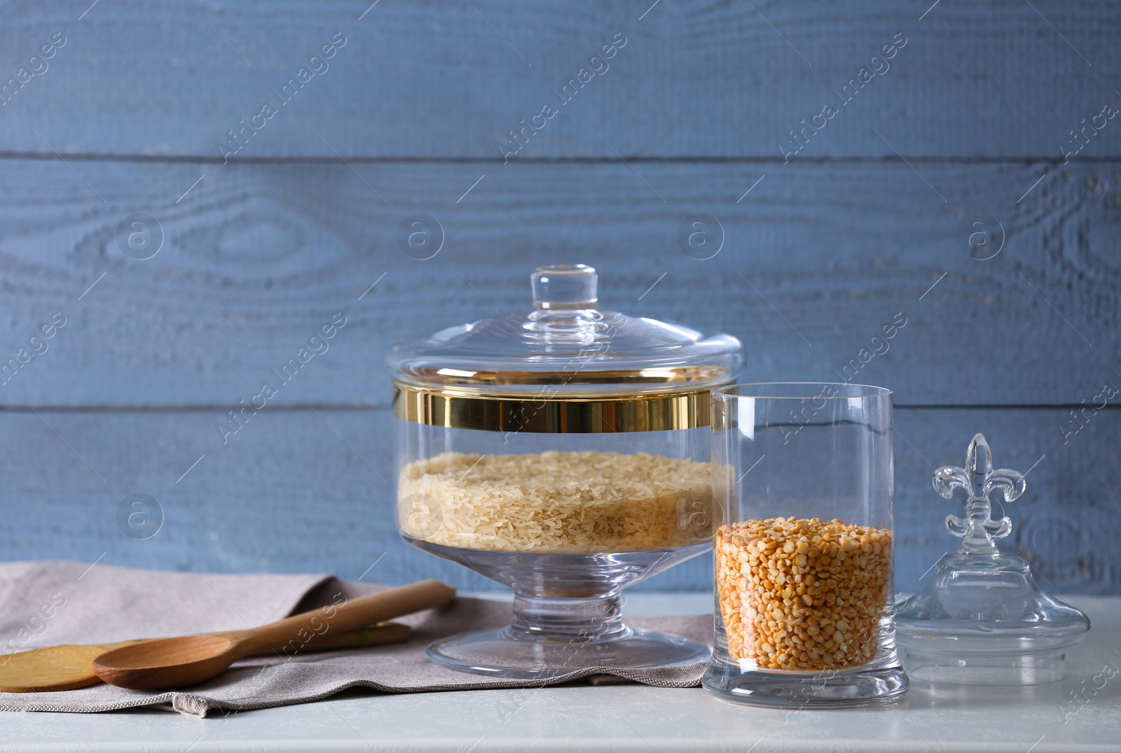 Photo of Cereals on grey table against blue wooden background. Foodstuff for modern kitchen