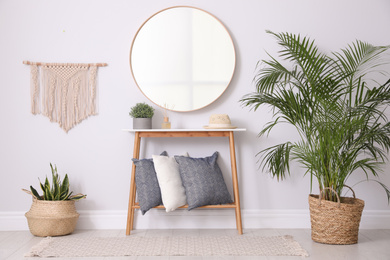 Photo of Round mirror and plants at home. Idea for interior design