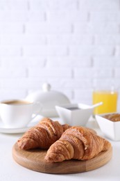 Fresh croissants on white table. Tasty breakfast