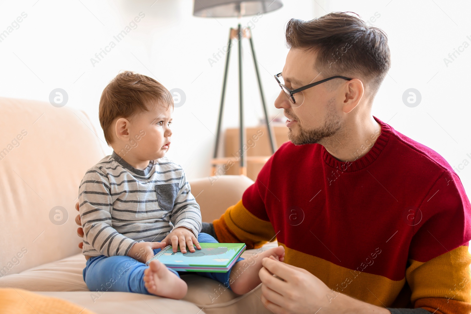 Photo of Dad spending time with his son at home